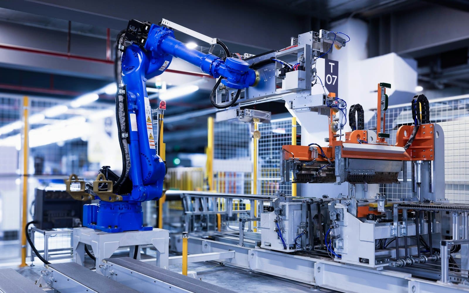 A robotic arm on an automated production line carrying out a process without manual intervention.